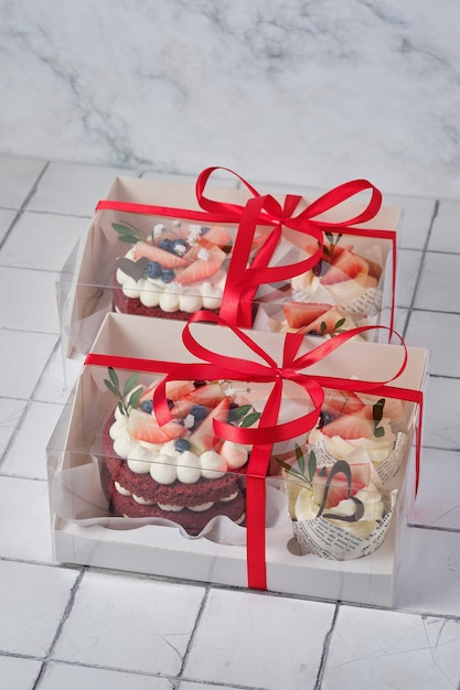 Gift set of desserts red velvet bento cake and red velvet cupcakes with strawberries