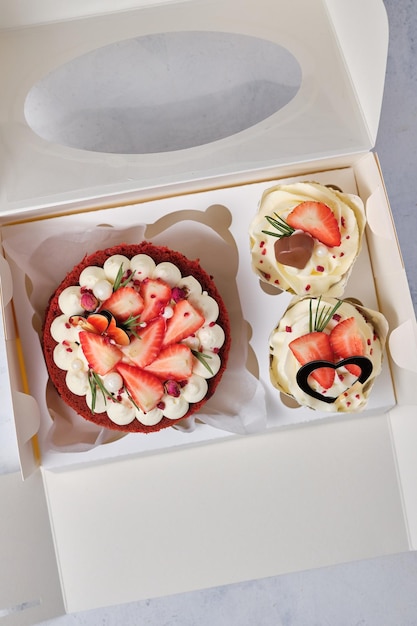 Gift set for the holiday Red velvet bento cake with fresh strawberries and red velvet cupcakes with strawberries chocolate and cream cheese cream