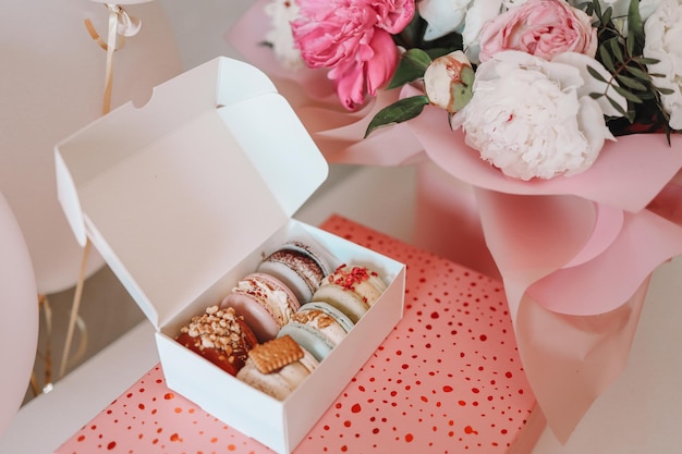 Gift set macaroons and a bouquet of flowers