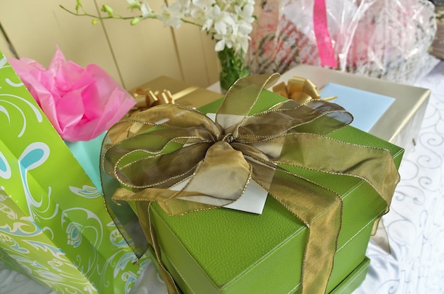 A gift table stacked with elegantly wrapped gifts and presents in bright cheerful colors