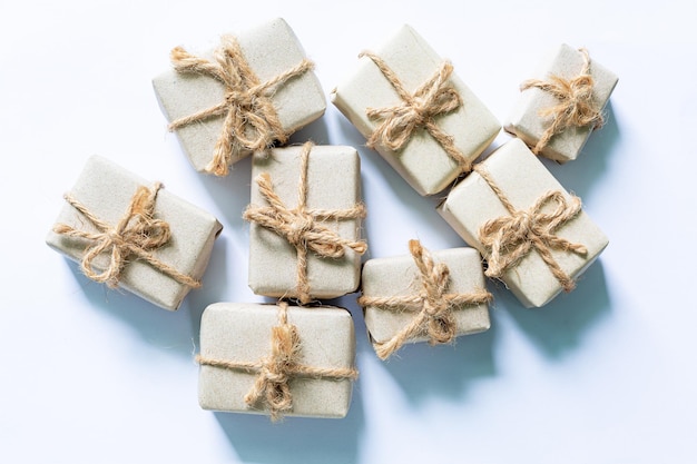 gift on a white background,Brown paper package with red gift tag in row of plain ones