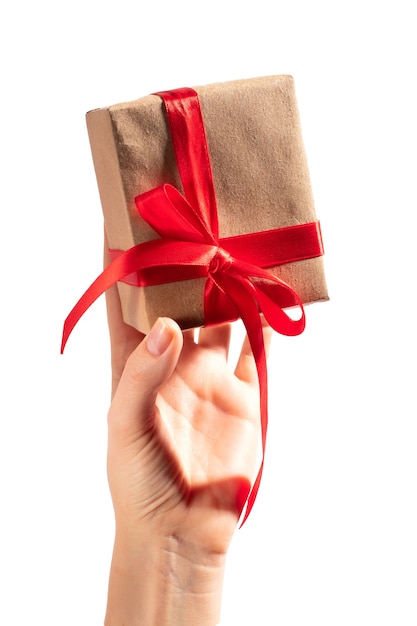 Gift with red ribbon in hand