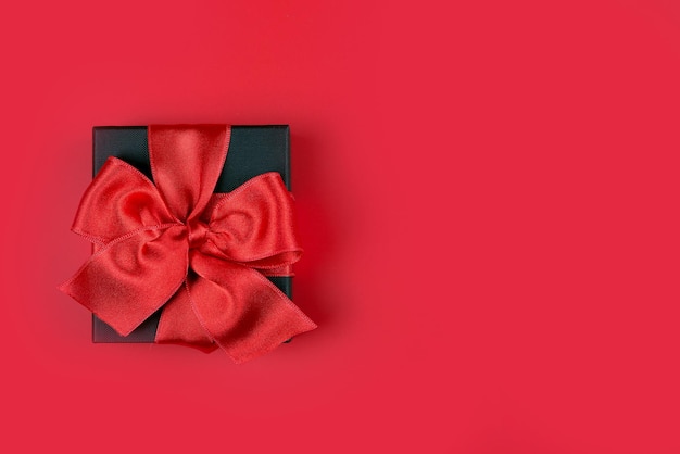 Gift with ribbon on a bright colored background with space for text