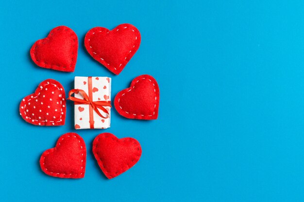 gift with ribbon and textile hearts on blue