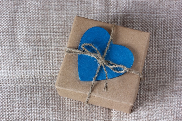 Gift wrapped in brown paper and tied with a rope.