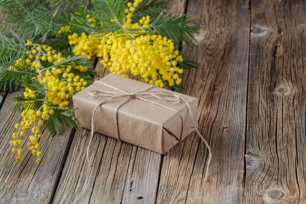 Gift wrapped in craft paper with yellow spring flower