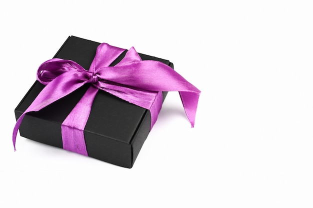 Gift wrapping black with purple bow on a white background.