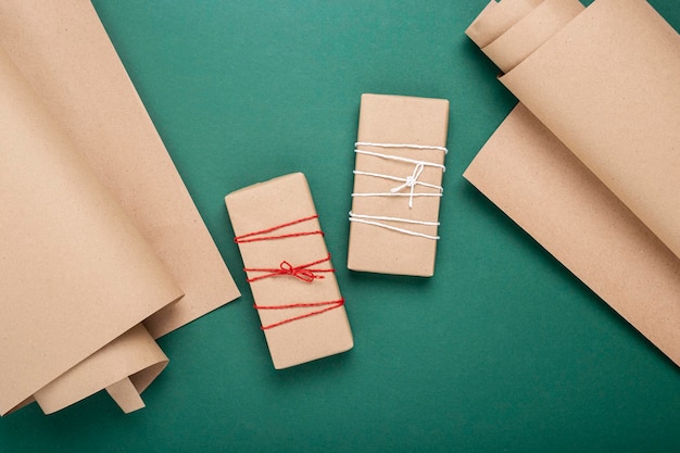 Gift wrapping craft paper on a green background Top view flat lay