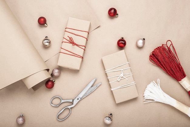 Gift wrapping, gifts, scissors, craft paper. Top view, flat lay.