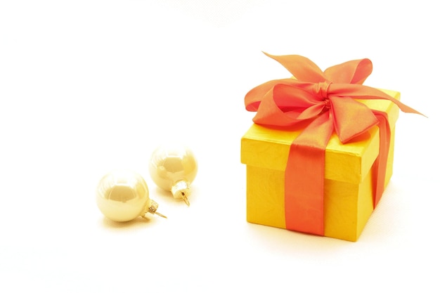 Gift yellow box with red ribbon on a white background Flat lay Christmas background