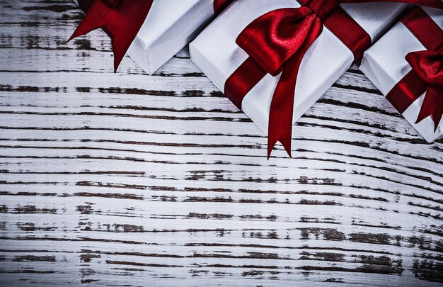 Giftboxes with tied ribbons on vintage wooden board holidays concept