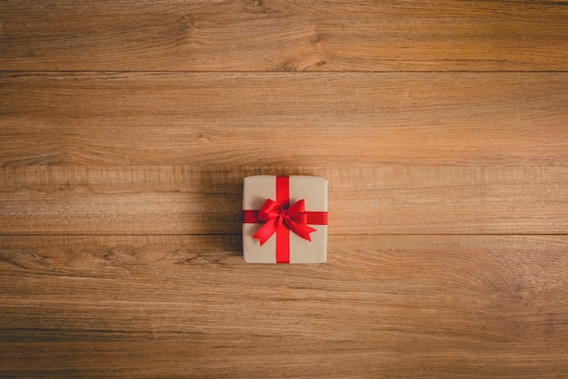 Gifts boxes with festive ribbons on wooden background