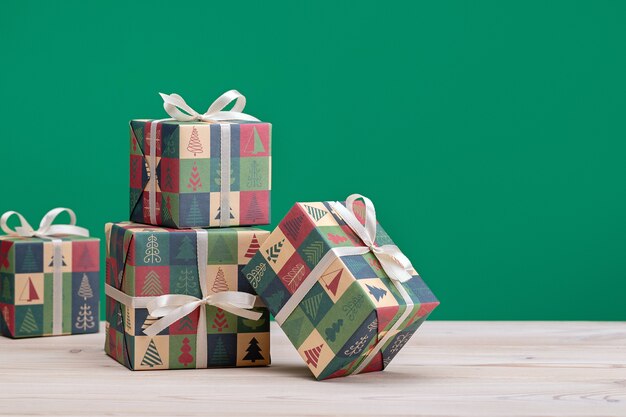 Gifts in boxes, wrapped in paper with Christmas and New Year pictures