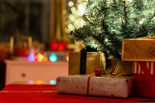 Gifts by christmas tree on floor