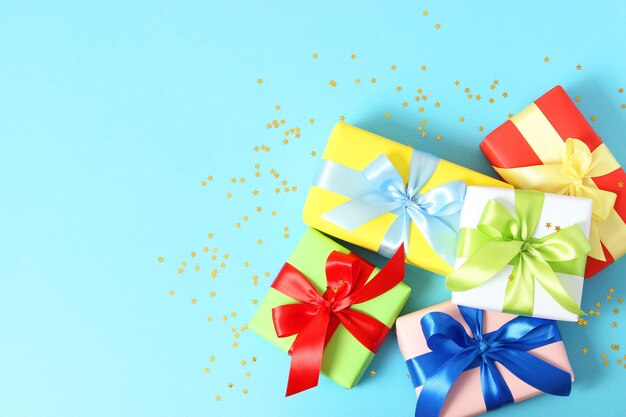 Gifts on a colored background top view holiday giving presents birthday