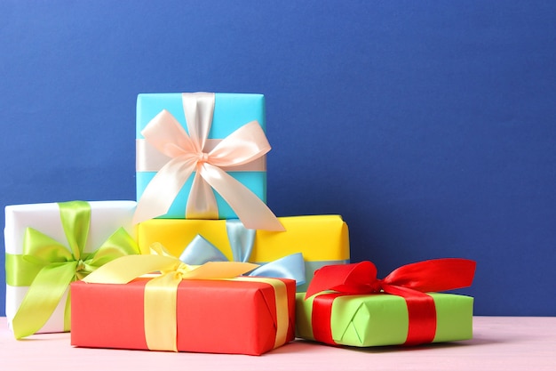 Gifts on a colored background top view holiday giving presents birthday