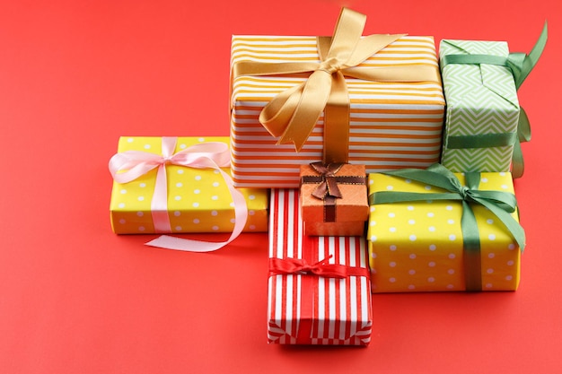 Gifts in colored paper with bows and paper sheet