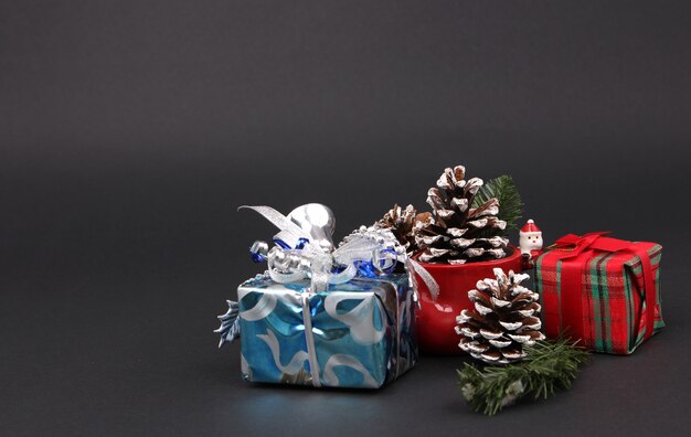 Gifts and decorations on Christmas Eve with black backdrop.