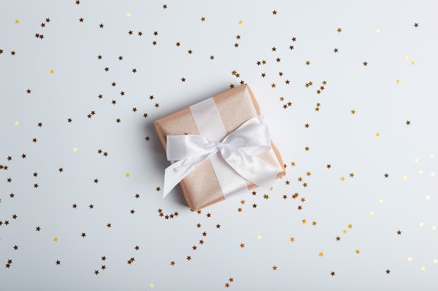 Gifts in gold packaging on a colored background with place for text