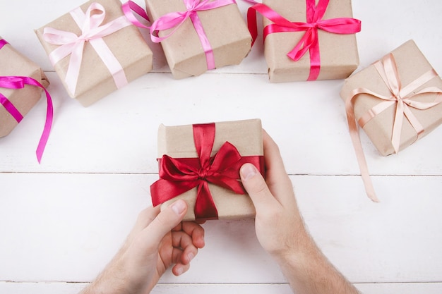 gifts in the hands on a light background