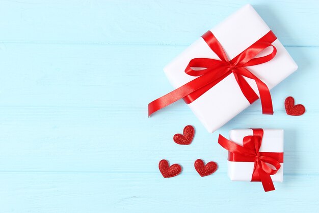 gifts and hearts on a colored background top view love
