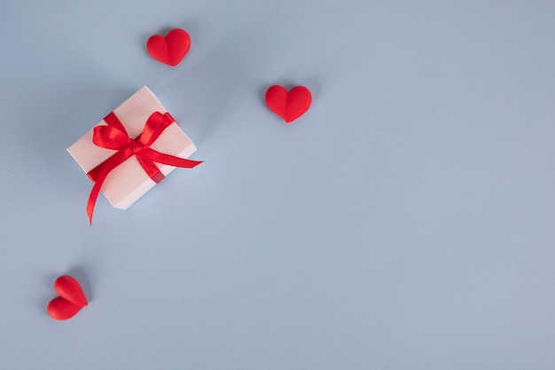gifts and hearts on pastel blue table.