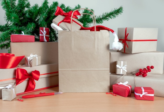 Gifts, Shopping bag, Christmas tree and Packing boxes on the table, delivery concept.