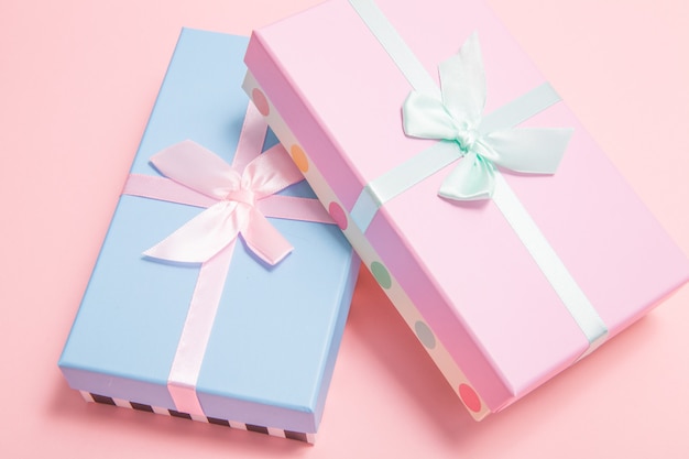 Photo gifts with bows on a pink background