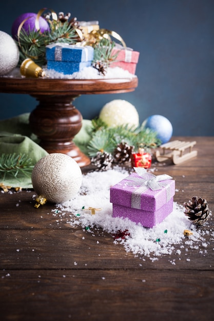 Gifts with christmas decoration on wooden cake stand