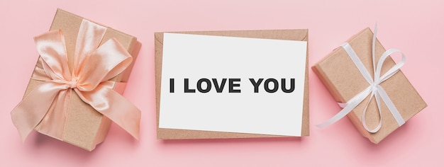 Gifts with note letter on isolated pink background, love and valentine concept with text I love you