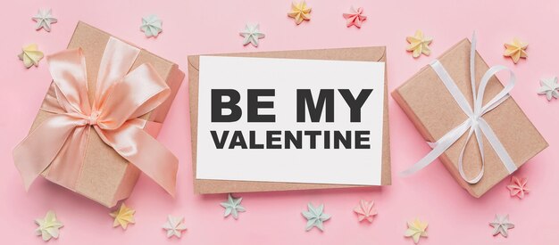 Gifts with note letter on isolated pink background with sweets love and valentine concept with text be my Valentine