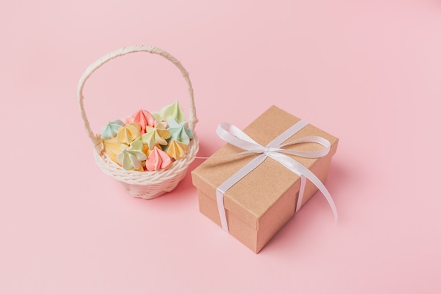 Gifts with sweets on isolated pink surface, love and valentine concept