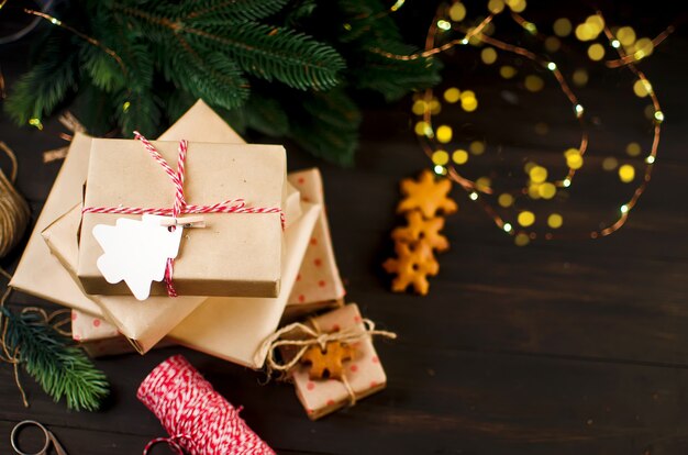 Gifts wrapped in craft paper and decorated with homemade gingerbread cookies