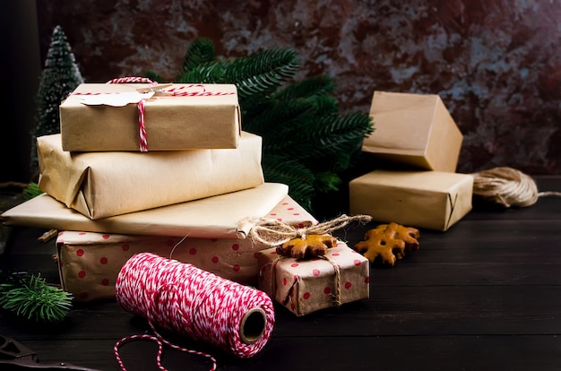 Gifts wrapped in craft paper and decorated with homemade gingerbread cookies