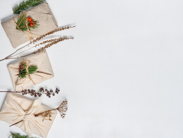 gifts wrapped in textile with vegetal decoration