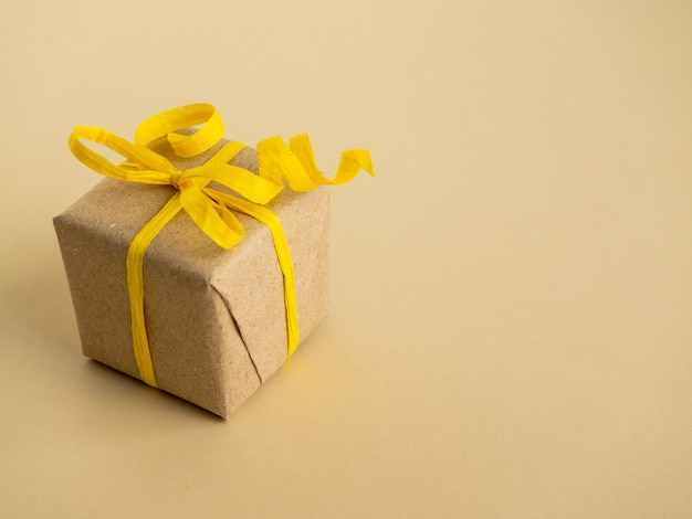 Gifts in yellow style on yellow surface. Gifts Packed in Kraft paper