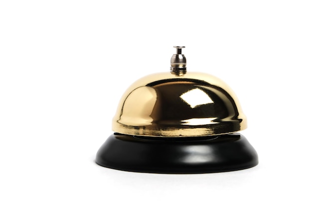 Gilded hotel service bell on a white background isolate