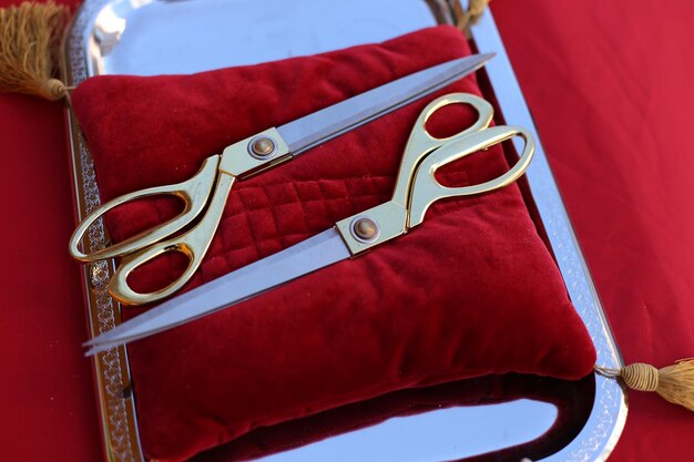 Gilded scissors on red cushion for cutting the ribbon for the opening ceremony