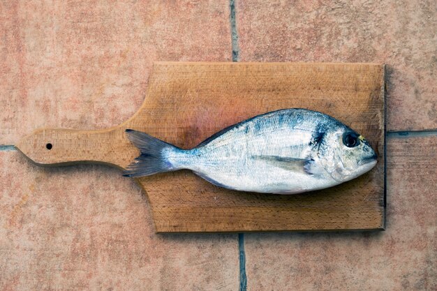 Gilthead seabream fish on the cutting board