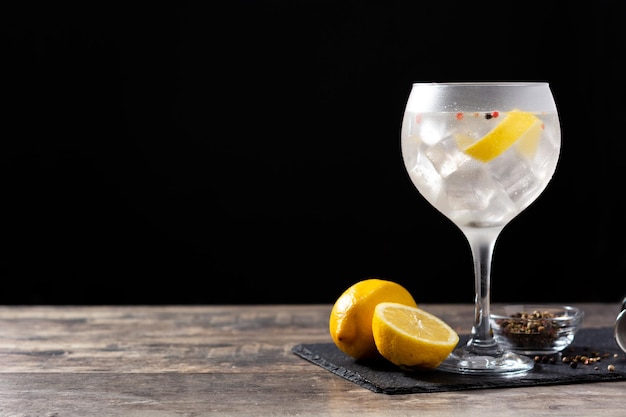 Gin tonic cocktail drink into a glass on wooden table