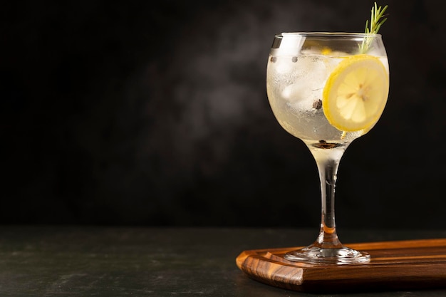 Gin Tonic garnished with lemon and rosemary