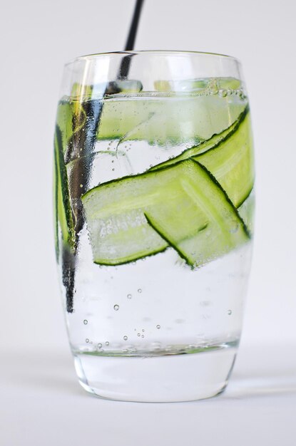 Gin and tonic with cucumber cocktail closeup sparkling water with bubbles