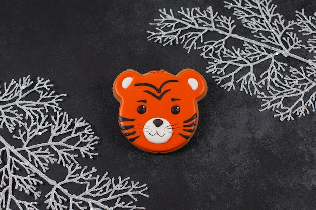 Ginger cookies in the form of tiger on dark background