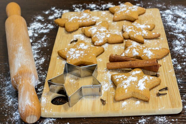 ginger cookies in the shape of stars on cutting board