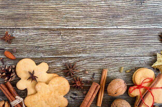 Ginger cookies on a wooden table with spices.