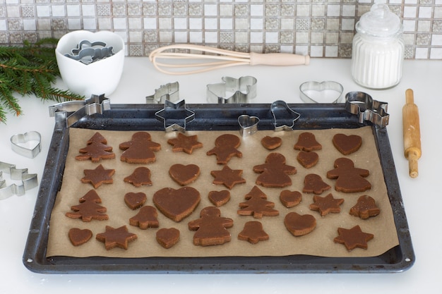 Photo ginger dough cookies are put on a baking sheet on the kitchen table