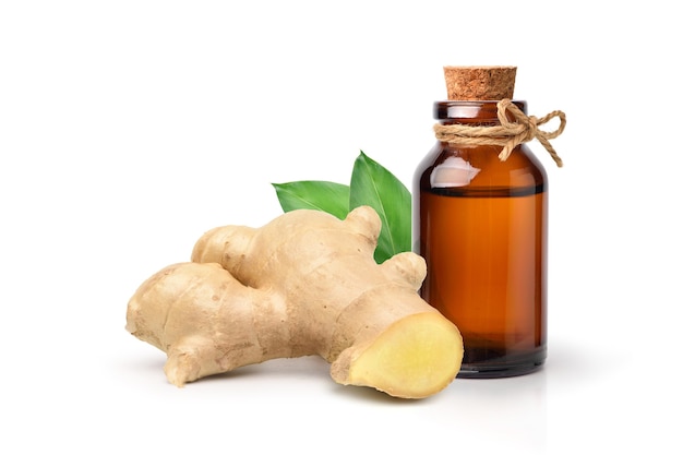 Ginger essential oil extract with rhizome and leaves isolated on white