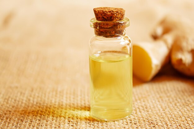Photo ginger essential oil in a small bottle selective focusnature