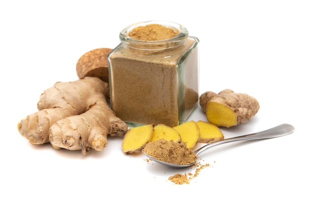 Ginger and a glass bowl with powdered ginger, isolated on white background.