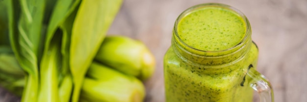 Ginger green apple smoothie on concrete background it can be used as a background banner long format